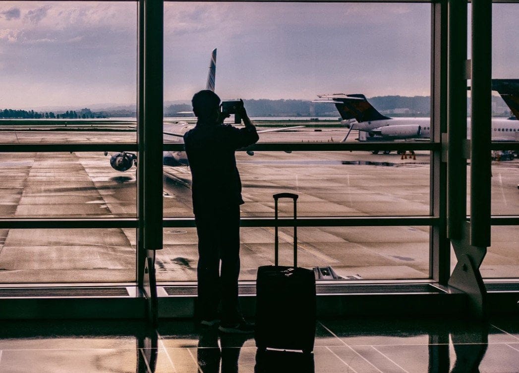 Drone equipment laid out for airline packing with carry-on and checked bag separation