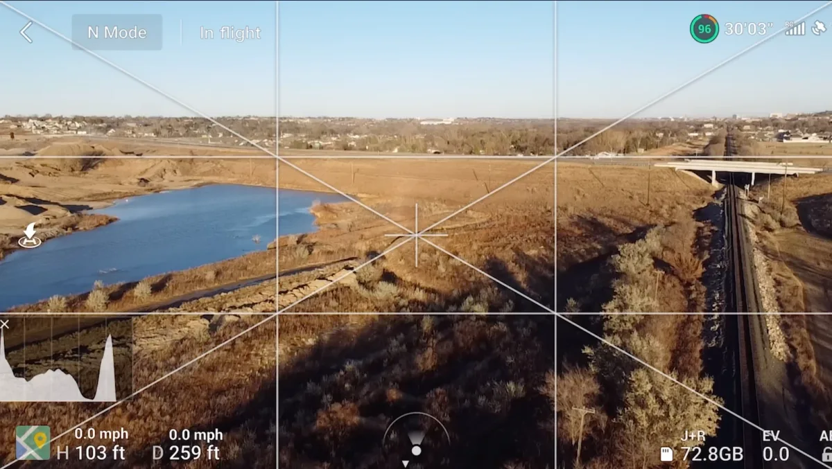 The DJI Fly camera interface in Normal mode showing the live feed with top telemetry bar, exposure histogram, map, and altitude and distance readouts