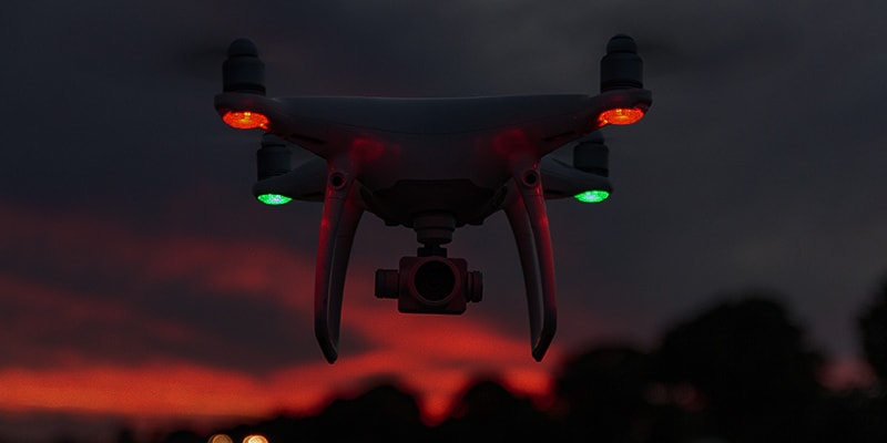 Drone lights at night showing red and green navigation lights